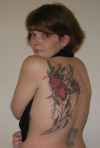 girl's back flower tattoo